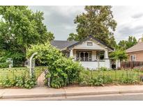 Charming home featuring a well-manicured lawn, garden, and inviting front porch at 342 9Th Ave, Longmont, CO 80501