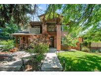 Charming two-story brick home with landscaped front yard and inviting walkway at 1934 S Sherman St, Denver, CO 80210
