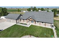 Charming single Gathering home with a landscaped front yard, 3-car garage, and covered entryway at 6331 County Road 32, Platteville, CO 80651
