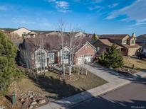 Charming single-Gathering home with a well-manicured lawn and mature trees in a desirable neighborhood at 15653 Split Creek Dr, Monument, CO 80132
