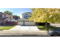 Charming two-story home with a three-car garage and well-maintained front yard at 12135 Elizabeth St, Thornton, CO 80241