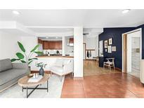 Cozy living room with tiled flooring, modern furniture, and an open layout to the kitchen at 2351 Federal Blvd # 102, Denver, CO 80211