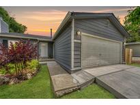 Charming home featuring a two-car garage, well-kept lawn and beautiful landscape at 4726 S Taft St, Morrison, CO 80465