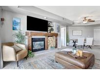 Inviting living room featuring a cozy fireplace, comfortable seating, and stylish decor at 920 E Plum Creek Pkwy # 306, Castle Rock, CO 80104