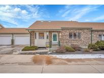 Charming single story brick home featuring an attached two car garage and manicured front yard at 2616 E Egbert St, Brighton, CO 80601