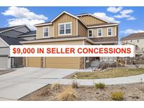 Inviting two-story home with a three-car garage and well-maintained front yard at 10913 Ledges Rd, Parker, CO 80134