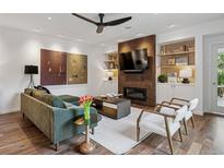 Inviting living room boasts a stone fireplace, built-in shelving, and cozy seating at 14 S Grape St, Denver, CO 80246