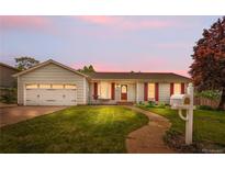 Charming single-story home boasts a well-manicured lawn, red shutters, and an attached garage at 16308 E Wyoming Dr, Aurora, CO 80017