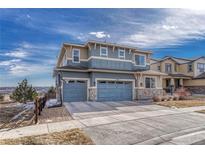 Inviting two-story home with a three-car garage and a basketball hoop in a Gathering-friendly neighborhood at 11796 Edenfeld St, Parker, CO 80134