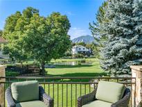 Deck overlooks pond, mountains, and lush green space at 2512 Premier Pl, Boulder, CO 80304