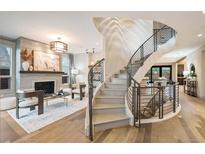 Bright living room with a fireplace, decor, and a modern staircase at 424 Grape St, Denver, CO 80220