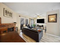 Comfortable living room with a fireplace, patio access, and entertainment center at 12354 W Nevada Pl # 102, Lakewood, CO 80228