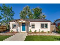 Charming single-story home with a well-manicured lawn and inviting blue front door at 1060 Grove St, Denver, CO 80204
