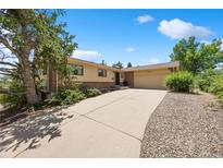 Inviting ranch-style home with a brick and siding exterior, featuring a spacious driveway and a well-maintained front yard at 2711 S Fenton St, Denver, CO 80227