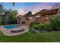 Inviting backyard features a sparkling pool, fire pit, deck, and lush landscaping at 92 S Devinney St, Golden, CO 80401