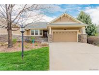Charming home with a manicured lawn and neutral exterior with an attached two car garage at 8525 E 149Th Dr, Thornton, CO 80602