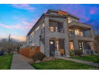 Striking modern home featuring stone accents and a private balcony at sunset at 2305 Quitman St, Denver, CO 80212