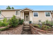 Charming home with a welcoming front entrance, landscaped garden and cozy, covered porch area at 2985 W 46Th Ave, Denver, CO 80211