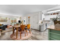 Open living space with modern finishes features a dining area, updated kitchen and sliding doors to the backyard at 2985 W 46Th Ave, Denver, CO 80211