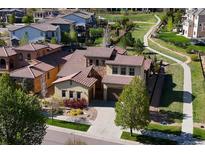 Beautiful aerial view of a two-story home in a lush community with manicured lawns and walking paths at 15179 W Washburn Ave, Lakewood, CO 80228