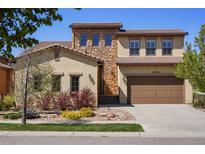 Beautiful two-story home with stone accents, a two-car garage, and a well-manicured lawn at 15179 W Washburn Ave, Lakewood, CO 80228