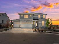 Beautiful two-story home featuring a three-car garage and stone accents, perfect for Gathering living at 3453 N Gold Bug Ct, Aurora, CO 80019