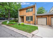 Charming townhome with wood siding, manicured lawn, and attached one car garage at 12655 W Bayaud Ave # 40, Lakewood, CO 80228