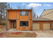 Two-story home featuring warm siding, a two-car garage, and a well-maintained lawn at 12655 W Bayaud Ave # 40, Lakewood, CO 80228