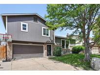 Charming two-story home with a well-maintained lawn, attached garage, and inviting curb appeal at 11041 Newland St, Westminster, CO 80020