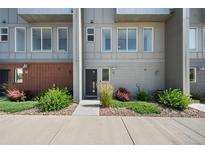 Modern townhome exterior highlighting clean lines, multiple windows, and tidy landscaping along a sidewalk at 8711 E Hampden Ave # 6, Denver, CO 80231