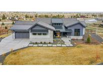 Beautiful single Gathering home with a stone and blue painted facade, nice yard and three car garage at 6736 S Flanders Ct, Aurora, CO 80016