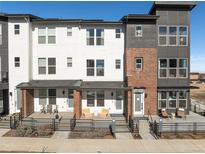 Modern townhomes featuring brick accents and stylish front patios for outdoor relaxation at 3109 W Bates Ave, Denver, CO 80236