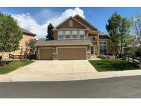 Charming two-story home featuring a three-car garage and well-manicured lawn at 22302 Quail Run Way, Parker, CO 80138