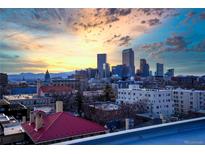 Sweeping city views showcasing Denver's skyline and the Rocky Mountains in the distance at sunset at 1300 N Ogden St # 304, Denver, CO 80218