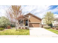 Charming single-Gathering home with well-maintained lawn, two-car garage, and cozy covered porch at 1358 14Th Ave, Longmont, CO 80501