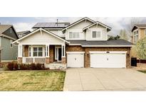 Charming two-story home with a stone facade, solar panels, and an attached two-car garage at 6103 S Millbrook Ct, Aurora, CO 80016