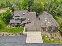 Expansive home featuring a three car garage, skylights, and mature trees at 6895 S Norfolk St, Foxfield, CO 80016