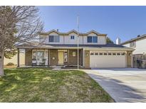 Charming two-story home with a well-manicured lawn, brick accents, and an attached two-car garage at 4160 E 115Th Pl, Thornton, CO 80233