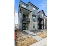 Beautiful modern home with stone accents, a covered porch, and professionally landscaped front yard at 16605 Peak St, Broomfield, CO 80023