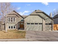 Charming two-story home featuring a well-maintained lawn, inviting entryway, and attached two-car garage at 5410 S Vivian St, Littleton, CO 80127