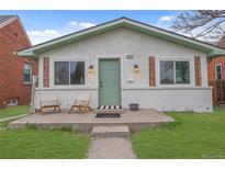 Charming bungalow with updated facade, lovely porch decor, and well-manicured lawn at 3619 N York St, Denver, CO 80205