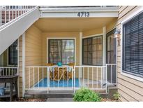 Inviting front porch with seating area and blue accent rug welcomes you home at 4713 Spine Rd # D, Boulder, CO 80301