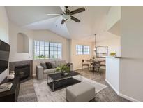 Bright living room with fireplace, vaulted ceilings and modern decor at 5705 N Genoa Way # 308, Aurora, CO 80019