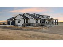 Beautiful single-story home with a stone facade and covered porch; a charming exterior design at 30355 E 161St Ave, Brighton, CO 80603