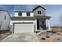 Charming two-story home featuring a large garage and well-maintained front yard at 2201 Flower Blossom Ave, Brighton, CO 80601