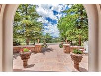 Stunning patio entrance with beautiful planters and stone detail surrounded by lush trees and view at 28 Indian Paintbrush Dr, Golden, CO 80401