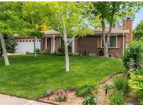 Charming brick home with a well-manicured lawn and mature trees at 2112 S Olathe St, Aurora, CO 80013