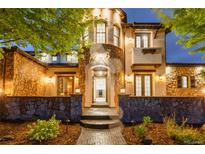 Grand entrance of home with stone accents, arched doorway, and manicured landscaping creating curb appeal at 1525 W 141St Way, Westminster, CO 80023