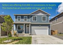 Charming two-story home with a well-maintained lawn and attached two car garage at 2417 Mountain Sky Dr, Fort Lupton, CO 80621