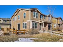 Two-story townhome with a fenced yard and landscaping at 10298 Tall Oaks Cir, Parker, CO 80134